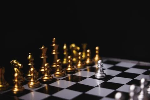 Silver pawn chess move forward to facing and challenge all gold chess pieces Stock Photos