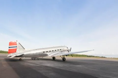 Silver plane parked in an empty lot Stock Photos
