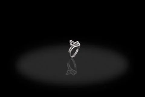 Silver precious two hearts ring female with diamonds on black background. Goo Stock Photos