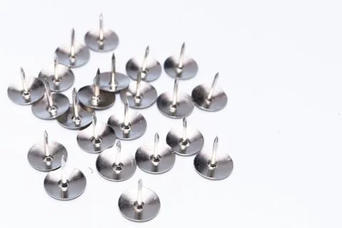 Silver Push Pins on White Background, Office Supplies, Close-Up View. Stock Photos
