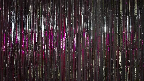 Silver rain from tinsel with pink light. Beautiful silver background with shiny Stock Footage 228587676
