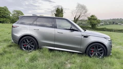 A silver Range Rover Sport parked in a countryside setting in the Cotswolds Stock Footage 308670597