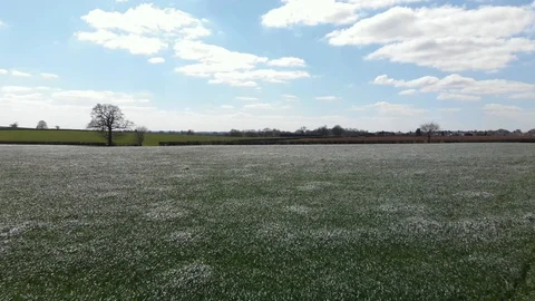 Silver Reflective Spring Grass Field England Midlands Flat Aerial Landscape 4K Stock Footage 106387317