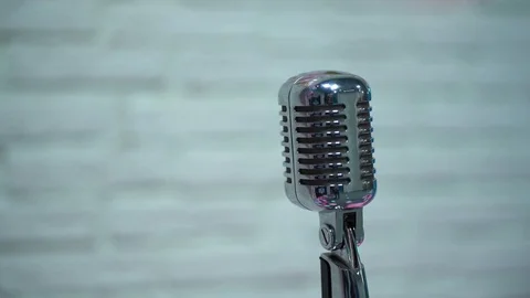 Silver retro glare microphone on stage in retro club close up. Spotlight shine. Video stock 119978876
