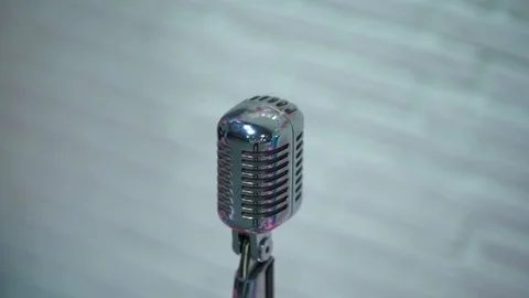 Silver retro glare microphone on stage in retro club close up. Spotlight shine. Stock Footage 119978887