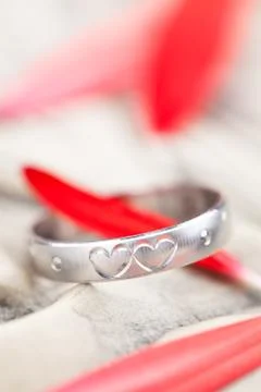 Silver Ring and flower  petals. Stock Photos