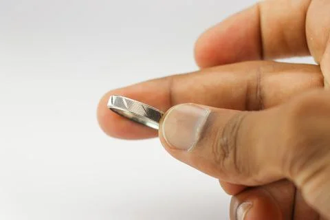 Silver ring with beautiful patterns held in the hand on a white background Stock Photos