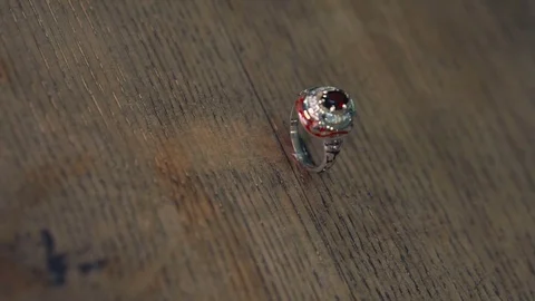 Silver ring with enamel and precious stones on a wooden surface Video stock 73813965