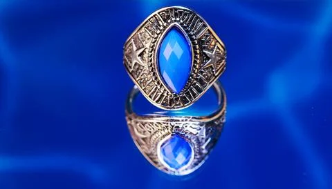 Silver ring featuring a large faceted blue stone Stock Photos