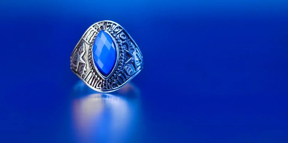Silver ring featuring a large faceted blue stone Stock Photos