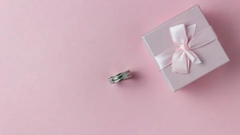 Silver ring go in a pink gift box on a pink background. Stock Footage 155310638