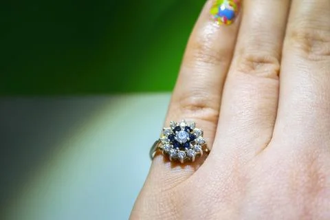 Silver ring in the hand on a light background, top view. Stock Photos