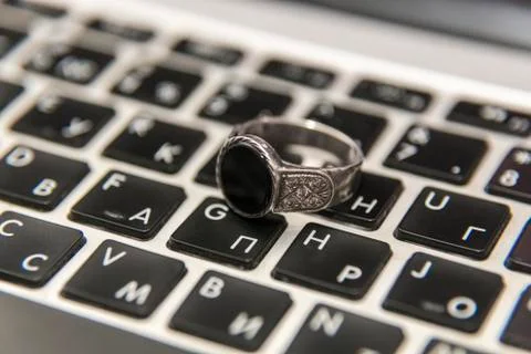 Silver ring on laptop keyboard Stock Photos