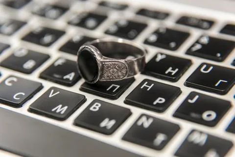 Silver ring on laptop keyboard Stock Photos