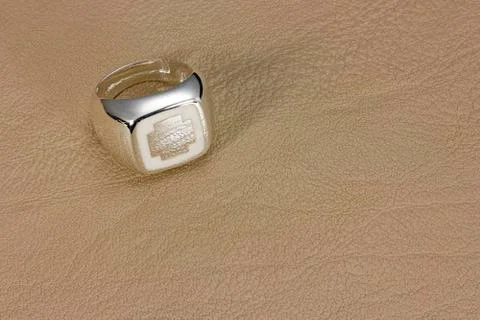 Silver ring on leather Stock Photos