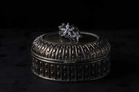 A silver ring lies on a silver box. Silver ring in the form of flowers. Antique  Stock Photos