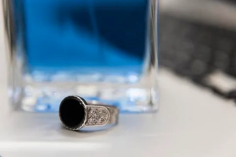 Silver ring, perfume and computer Fotos Stock