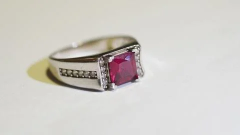 Silver Ring with Red Gemstone on White Background Stock Photos