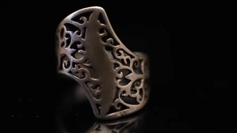 Silver ring rotating on a dark background. Video stock 150650711