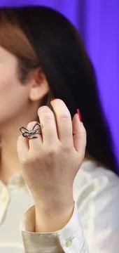 Silver ring with twisted loop design worn on finger Stock Photos