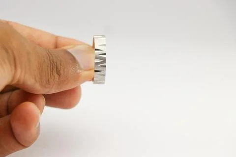 Silver ring of a unique design used as a fashion jewelry held in the hand 스톡 사진