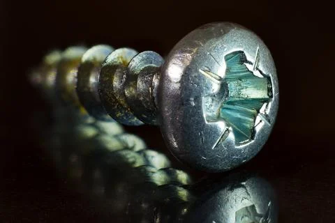 Silver screw on a dark background, macro photo. Stock Photos