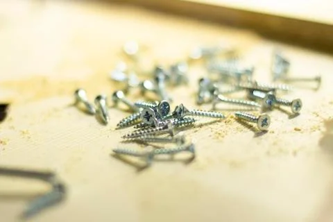 Silver screws are on the table Stock Photos