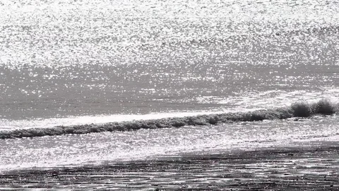 Silver sea with gentle breakers Stock Footage 73338839
