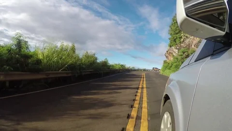 Silver Sedan Point Of View Driving Up A Narrow Road On A Sunny Day With Blue Sky Stock Footage 83927442