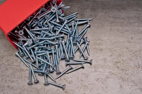 Silver self tapping screws a lot. Texture background. Stock Photos