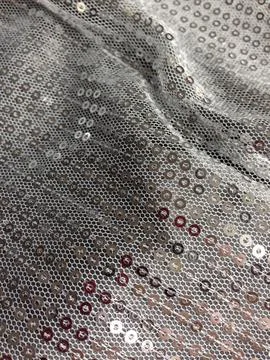 Silver sequin fabric with shiny decorative pattern Stock Photos