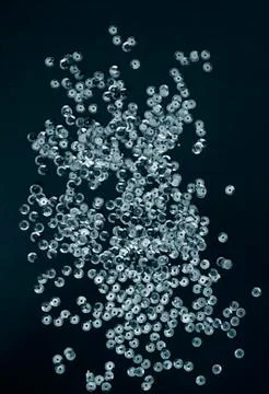 Silver sequins on black background Stock Photos