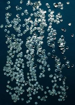 Silver sequins on blue background Foto stock