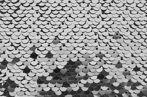 Silver sequins cloth background, festive glittering bright abstract backdrop. Stock Photos