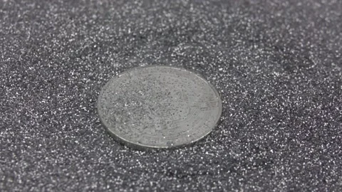 Silver sequins falling on cryptocurrency bitcoin. Stock Footage 155544161