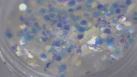 Silver sequins in a jar rotate in a circle Stock Footage 219484167