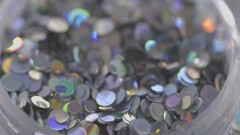 Silver sequins in a jar rotate in a circle Stock Footage 219484341