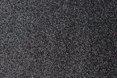 Silver sequins pattern. Sparkling sequins on black wool fabric as background Stock Photos