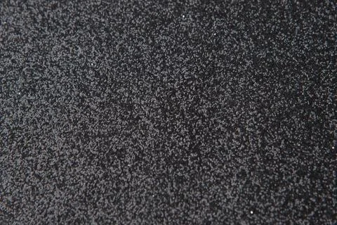Silver sequins pattern. Sparkling sequins on black wool fabric as background Stock Photos