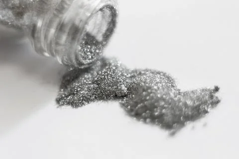 Silver sequins. a scattering of silver glitter texture and background Stock Photos