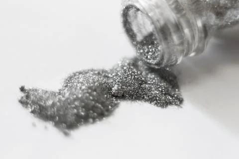 Silver sequins. a scattering of silver glitter texture and background Stock Photos