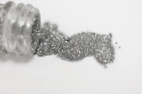 Silver sequins. a scattering of silver glitter texture and background Stock Photos