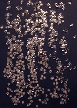 Silver sequins on violet background Foto stock