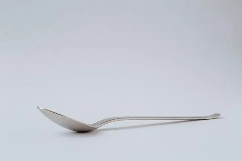 Silver shiny spoon on white background, kitchenware, copy space Stock-Fotos