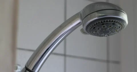 Silver shower covered in Lime scale head leaking water drops close up Stock Footage 156788753