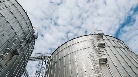 Silver silos against the sky background. Large grain elevators in a sunny day. Stock Footage 148089017