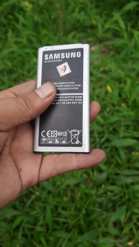 Silver smartphone battery pack, vertical lithium-ion cell with black warnin.. Video stock 345114356