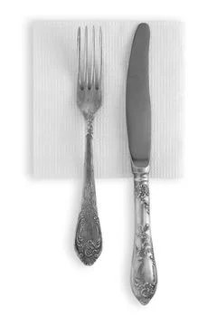 Silver spoon and fork on white napkin isolated Stock Photos