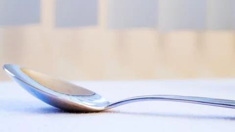 Silver Spoon Close Up On White Table. Stock Photos