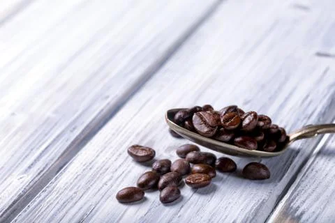 Silver spoon with coffee beans Stock Photos